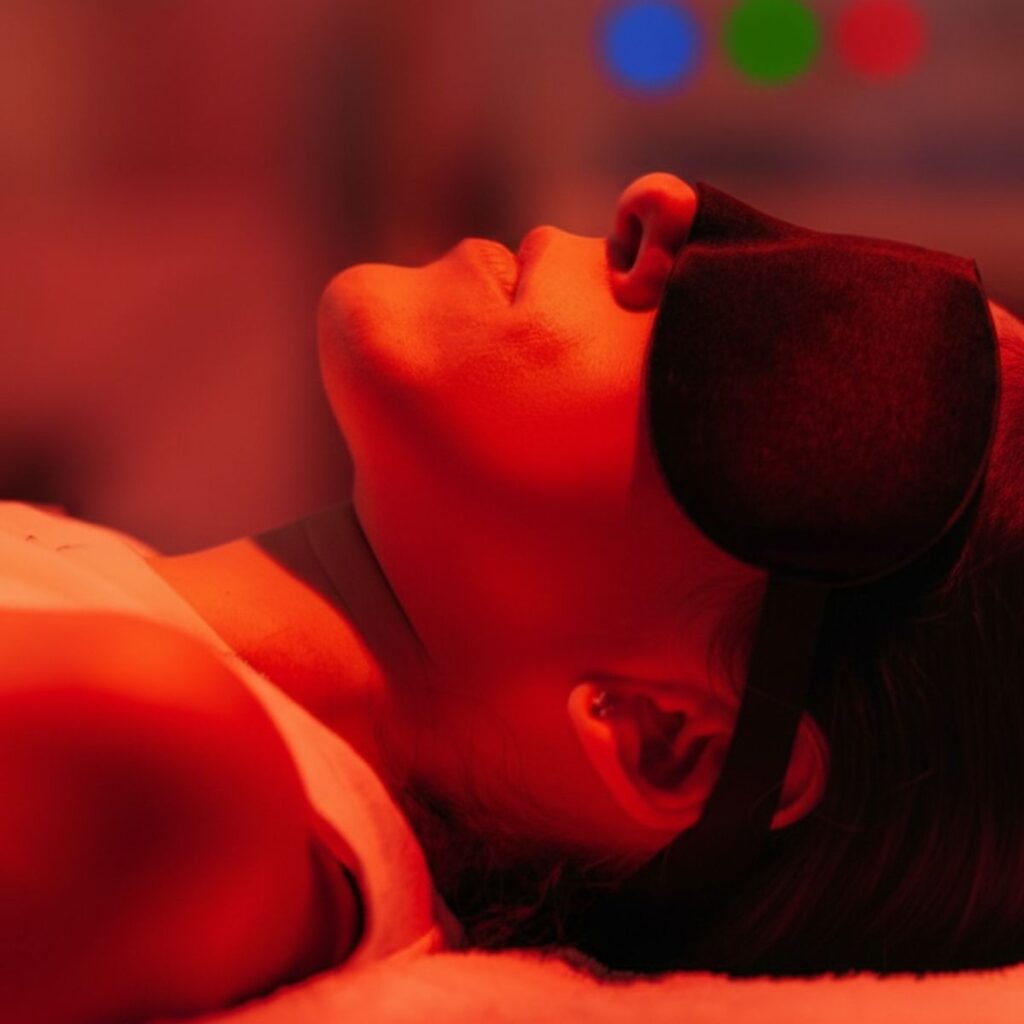 Patient receiving red light therapy treatment for skin rejuvenation and post-surgical recovery at Aestira in Miami.