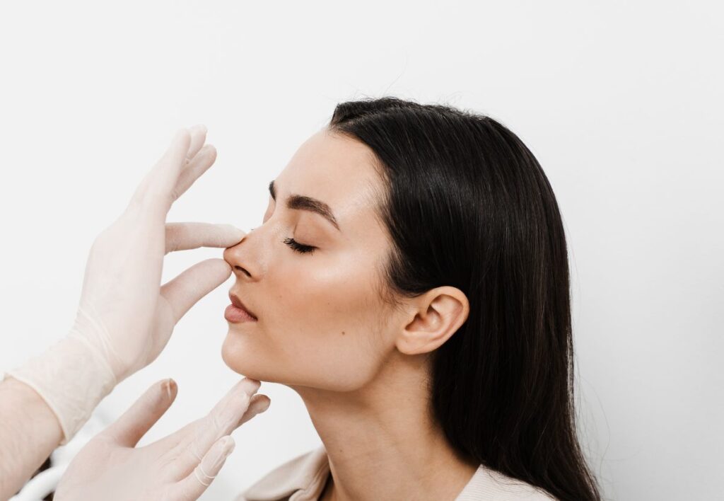 Middle Eastern woman during a rhinoplasty consultation highlighting balanced nasal refinement at Aestira in Miami.